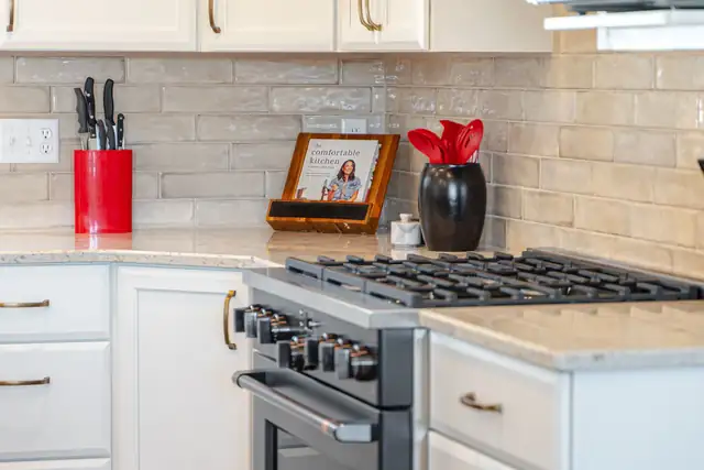 Brookfield kitchen remodel with white cabinets, gas range, glossy tile backsplash and quartz counters