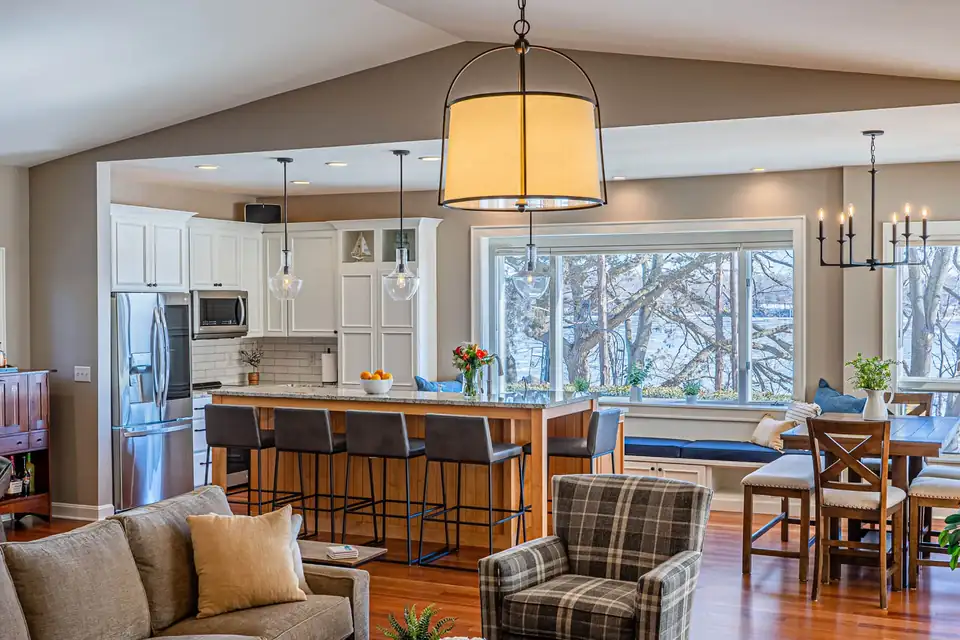 Kitchen remodeling Delafield WI area: Oconomowoc open kitchen with wood island, white cabinets and a great room with large picture windows