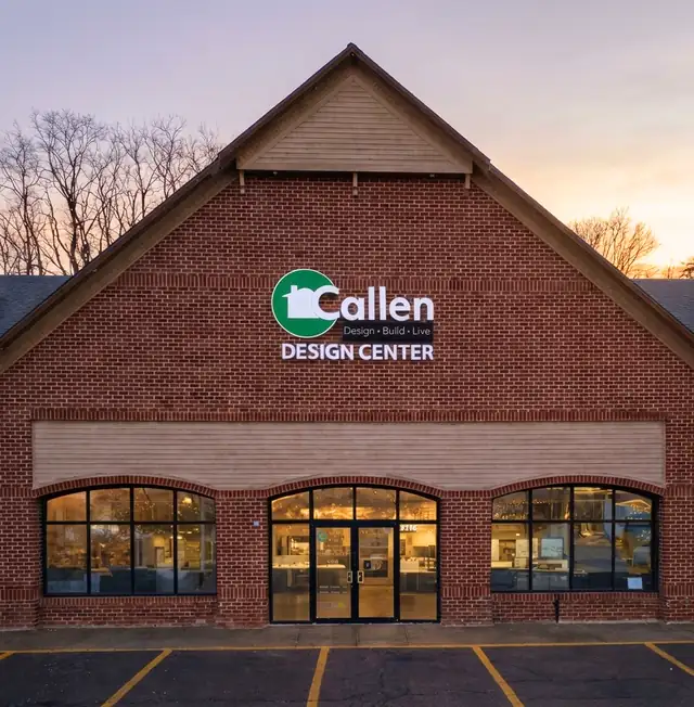The brick Callen Design Center building in Delafield, WI, lit at dusk